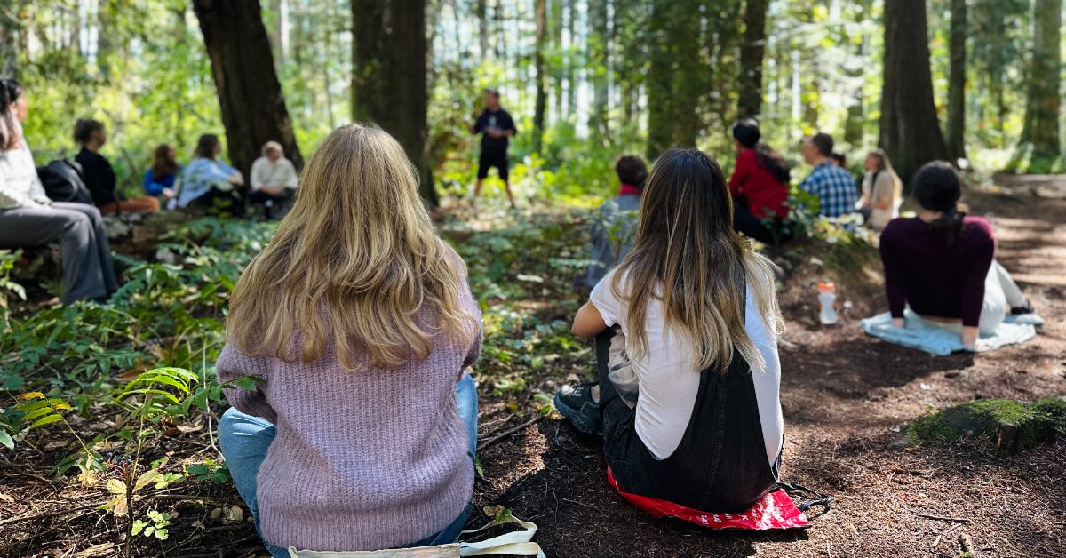 Health Planet Club members seated in forest