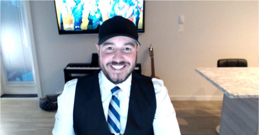 RRU student Leighton Gall sitting, smiling for a photo inside his home