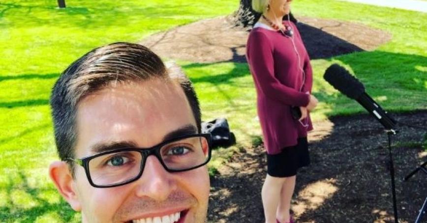 Chris Shewchuk takes a selfie of himself and Dr. Bonnie Henry standing outdoors by a microphone.