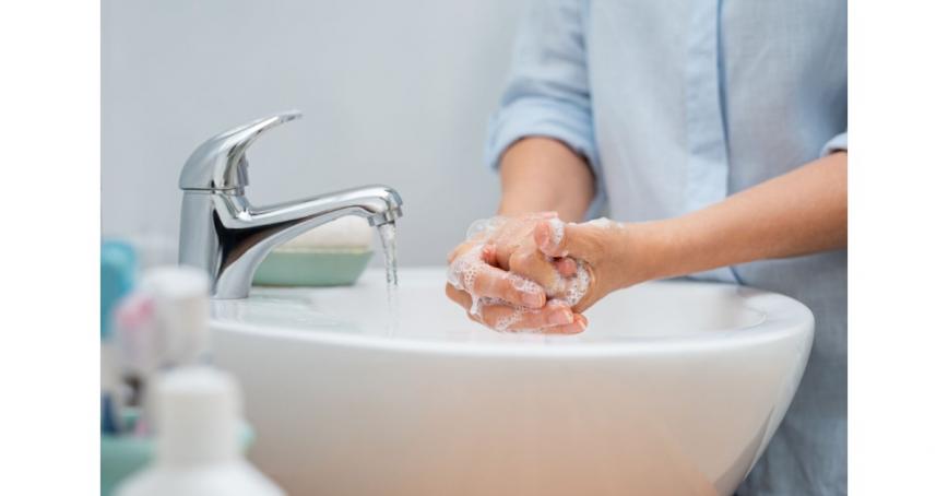 Person washing hands at a sink