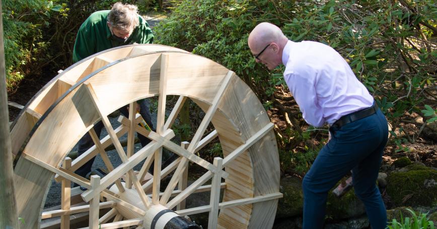  President Philip Steenkamp and Gardener Greg Higgs start the water wheel.