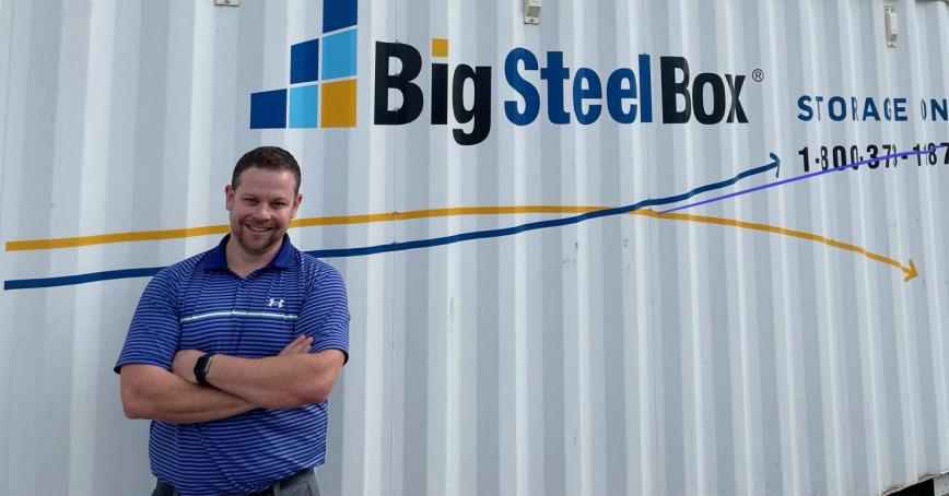 Man standing arms crossed against the Big Steel Box storage container