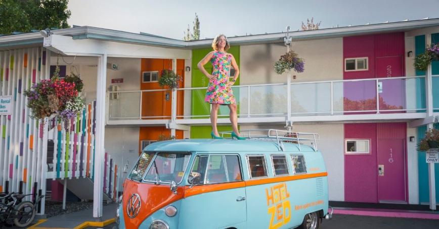 Hotel Zed CEO Mandy Farmer stands on the hotel's vintage VW bus. Photo by Women of Influence. P