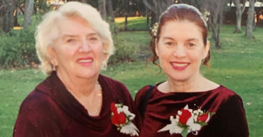 Mother Wilma Colford and daughter Mary Bernard formally dressed, standing outside on a summers day.