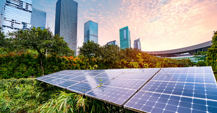 Solar panels can be seen in the foreground of a city scape.