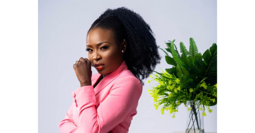 Head shot of Oluwafisayo Olayinka-Bello standing with her back to a plant filled vase