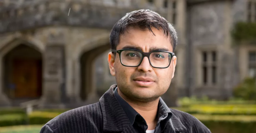 Head shot of Ash Prasad standing in front of Hatley Castle