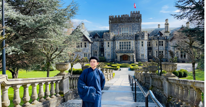Will Nguyễn walking up the steps in front of Hatley Castle on a clear day