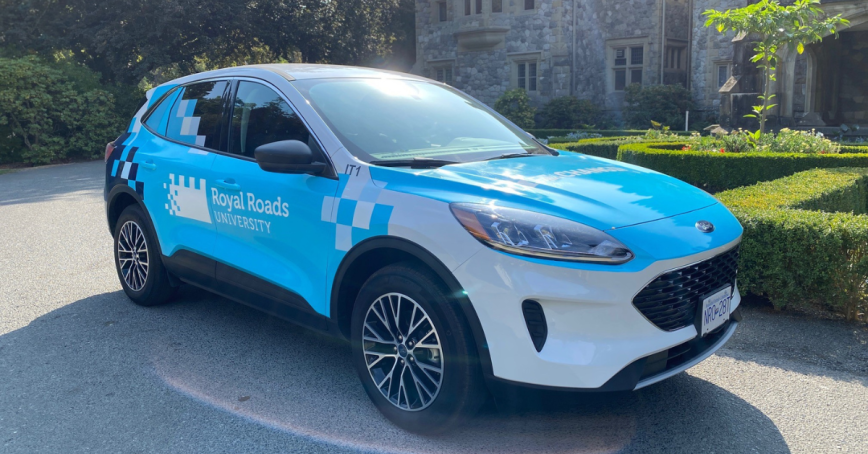 RRU branded electric vehicle in front of castle.