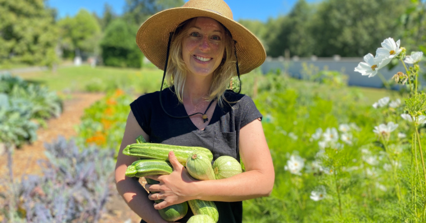 Solara Goldwynn holds an armfull of zuchinni.