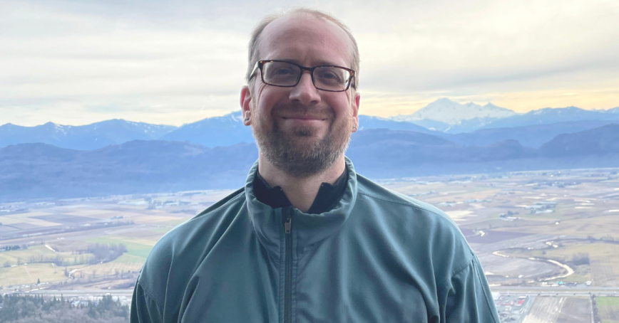 Robert Newell stands in front of the ocean.