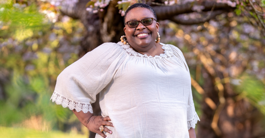 Head shot of Judith Obatusa in a garden.