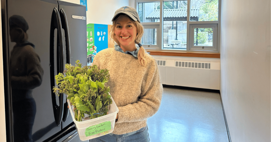 Women standing in front of a fridge holding a bucket of freshly picked rapini.