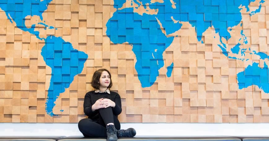 student sitting infront of map