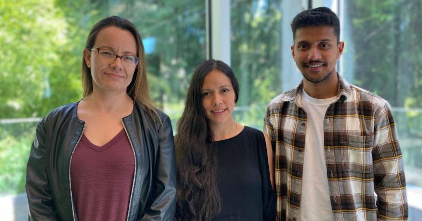 Alejandra Chacon Gallardo, Katherine Matos and Jofri Issac stand in the RRU library.