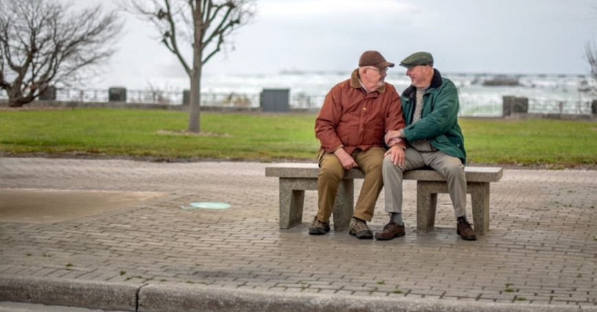 Two people sitting on a bench