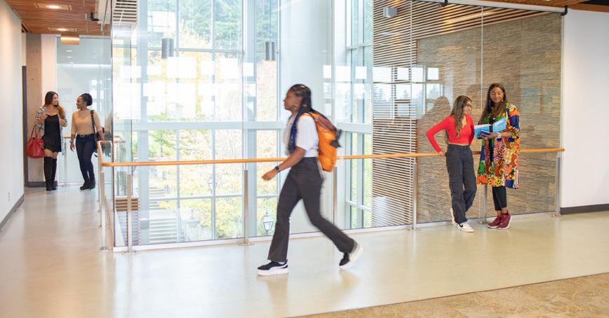 A bustling hallway full of students at Royal Roads University 