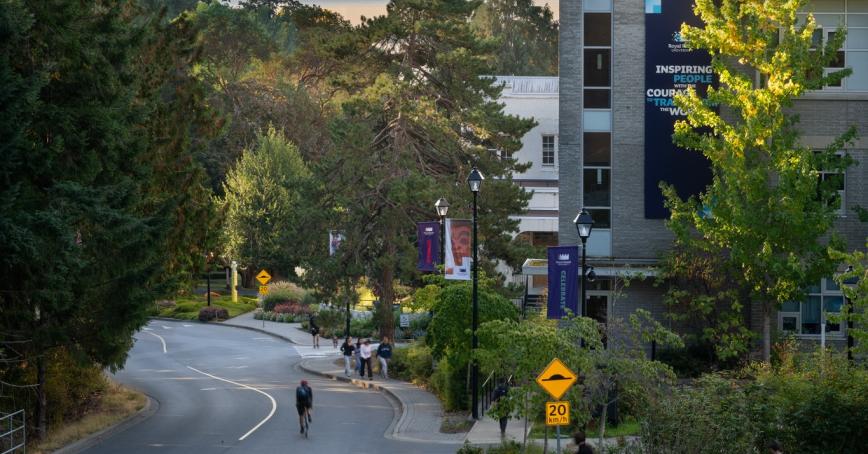 view of University drive hill with buildings and water at dusk