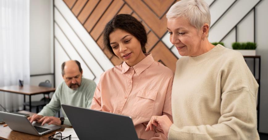 Three people working, a middle age male, young lady and older lady 