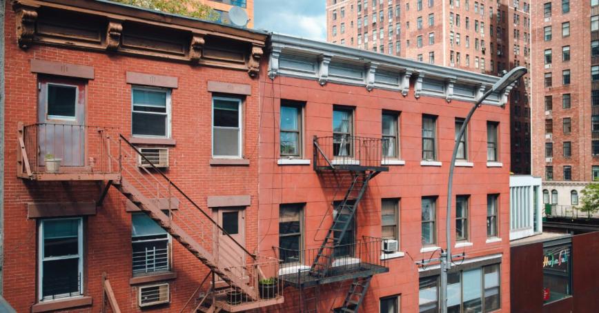 A red brick apartment building in an urban setting