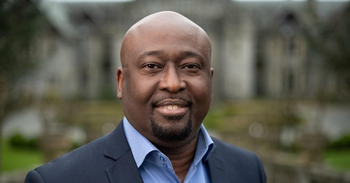 Nkem Onyegbula in a blue suit outside Hatley Castle.