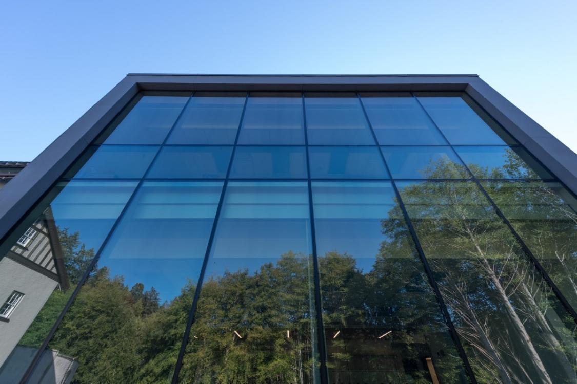 Royal-Roads-building-mirrored-windows-with-trees-reflected