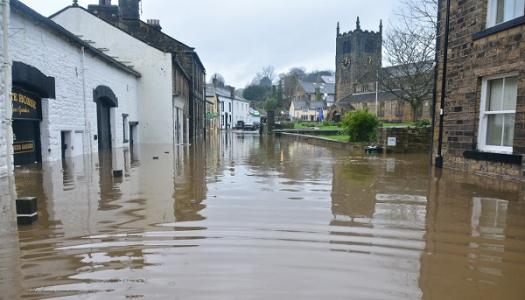 Town flooded with water with many of the buildings half under the water.