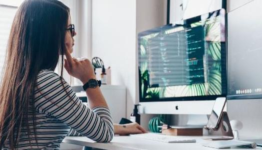 person-with-glasses-looking-at-desktop-computer