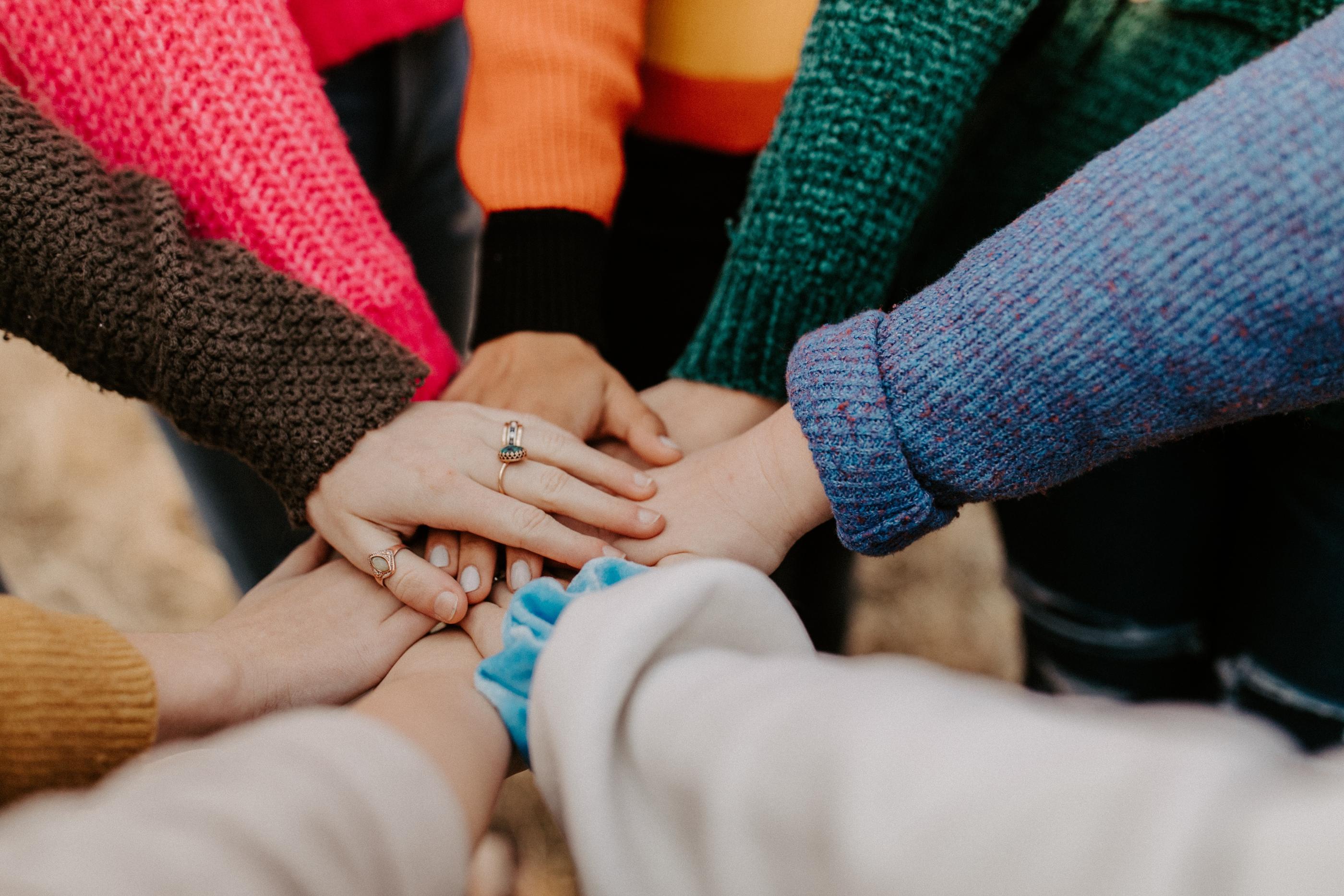 girl friends hands piled together