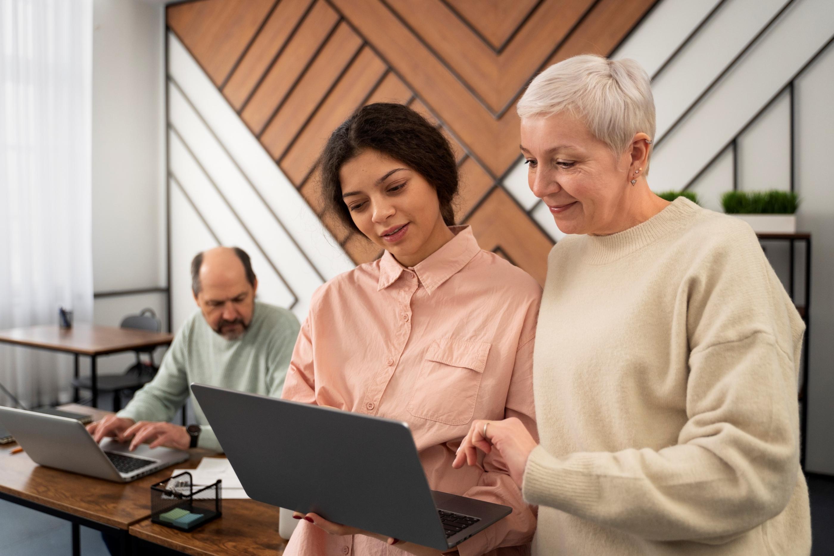 Three people working, a middle age male, young lady and older lady 