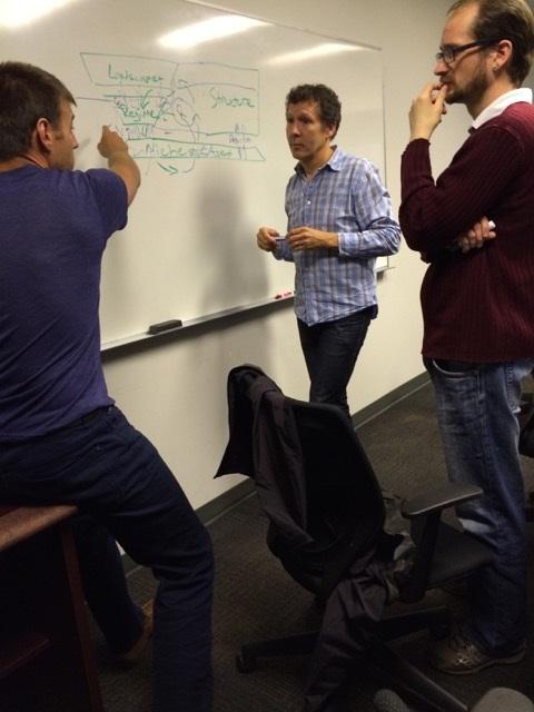 Robert Newell and two other people working and looking at white board