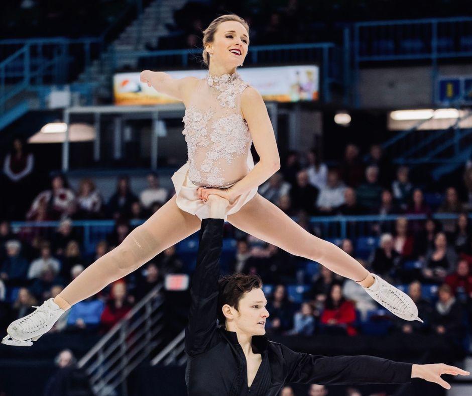 Camille Ruest and Andrew Wolfe performing a lift while figure skating.