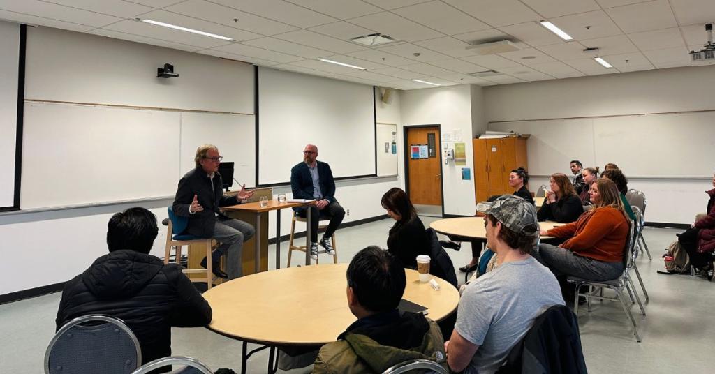 Anthony von Mandl speaking to a classroom of business students. 