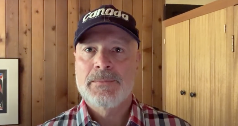 President Philip Steenkamp in a Canada hat and plaid shirt.