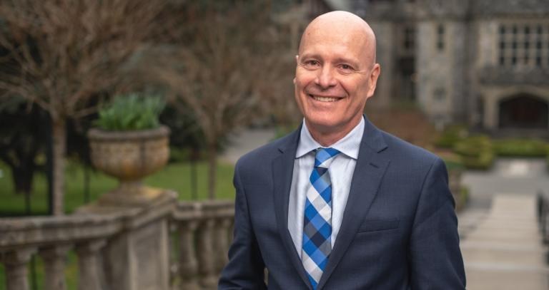 President Steenkamp smiling in front of Hatley Castle