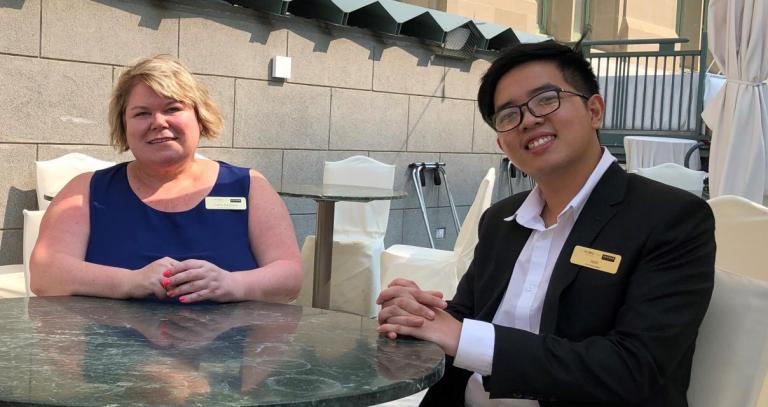 picture of Cathy and Josh at a patio table