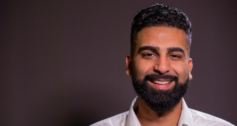 Head shot of Karandeep Manak with grey background