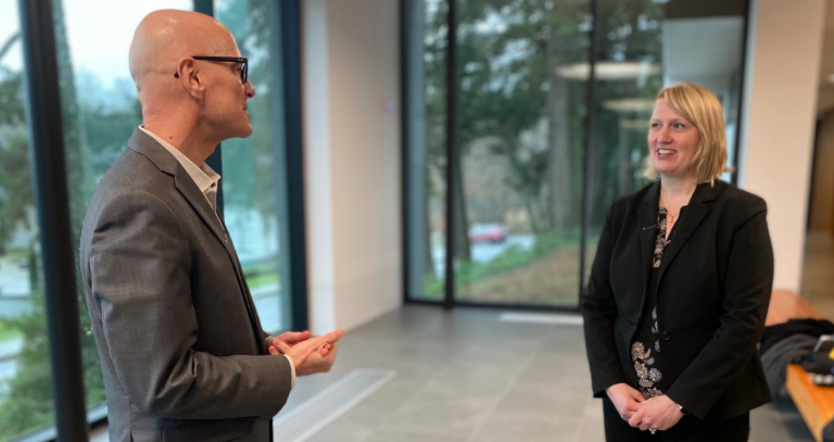 Philip Steenkamp and Tracy Smith-Carrier have a conversation in the lobby of the Dogwood Auditorium.