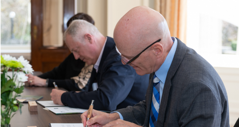 President Steenkamp signing an MOU at the same time as the presidents of VIU and Pearson College.