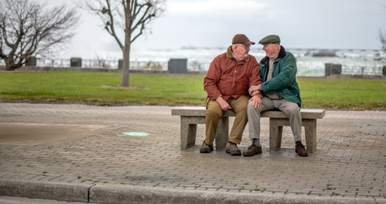 Two people sitting on a bench