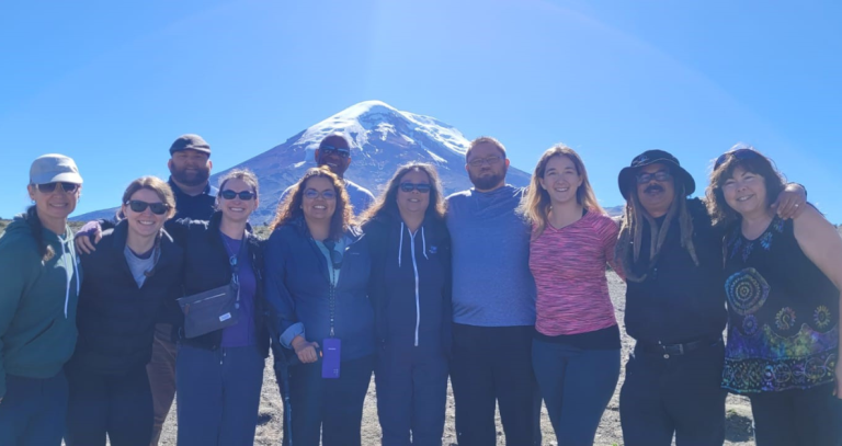 group of magl students standing in front of a mountain