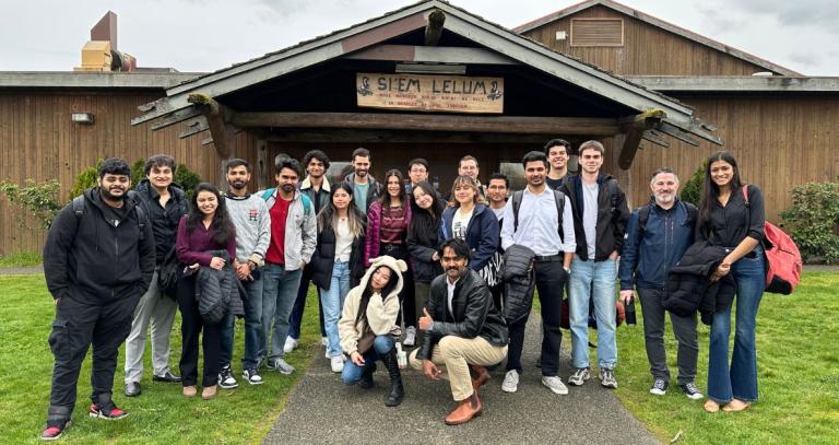 Group of BBA students standing in front of Cowichan Tribes building.