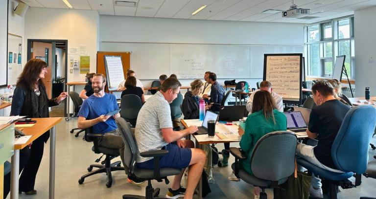 A class of MBA students work at their desks