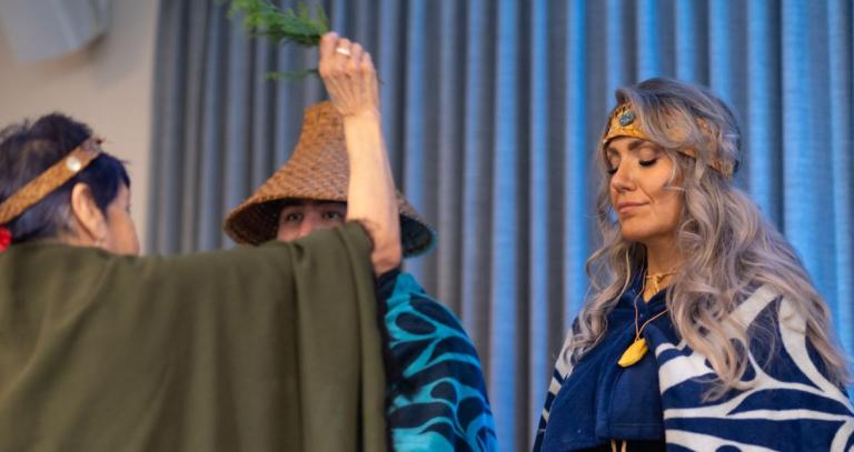 Tasha Brooks standing during ceremony at Indigenous Graduation. 