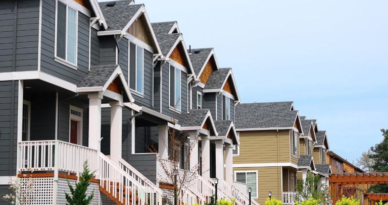 A row of newly built houses lines a street