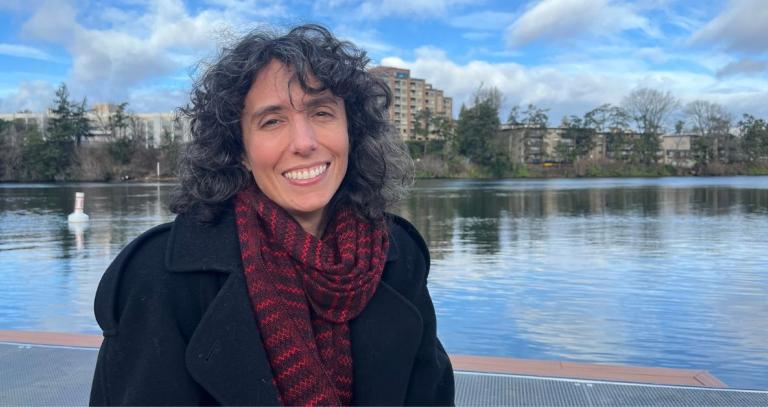 Melinda Quintero smiling in front of a lake. 