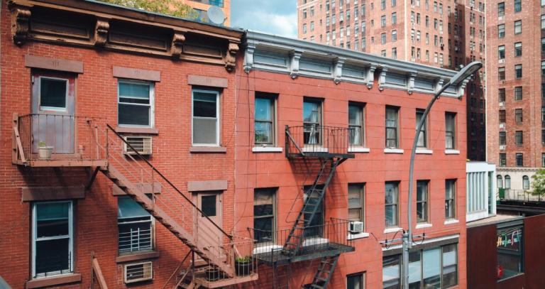 A red brick apartment building in an urban setting