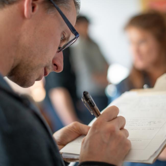 Student writes on clipboard