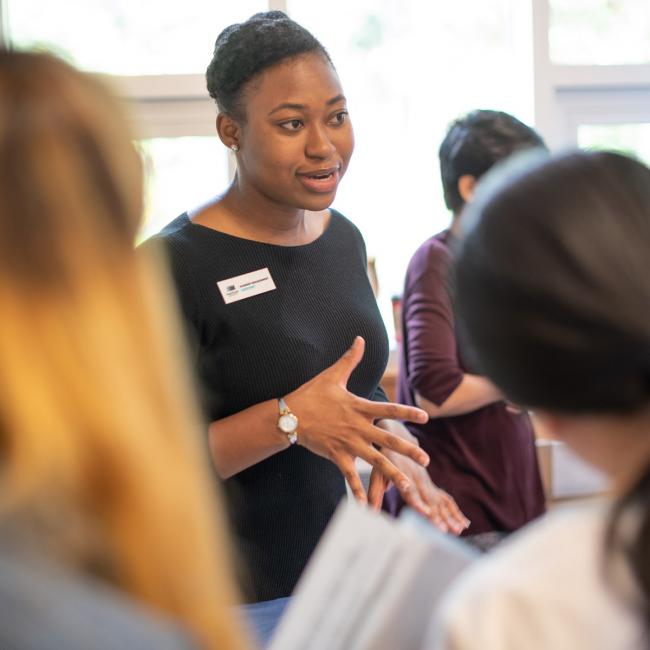 Student-with-nametage_speaking-to-other-students