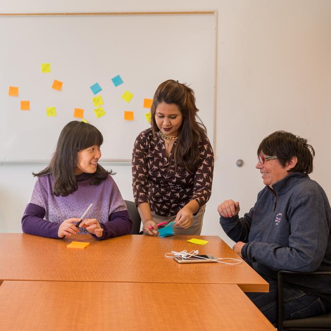 Students-in-class-whiteboard-sticky-notes-behind